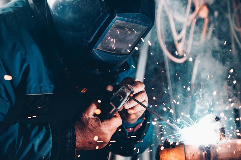 Welder joining steel, sparks visible
